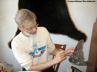 Steve Wilson examining dead Boreal Owl
